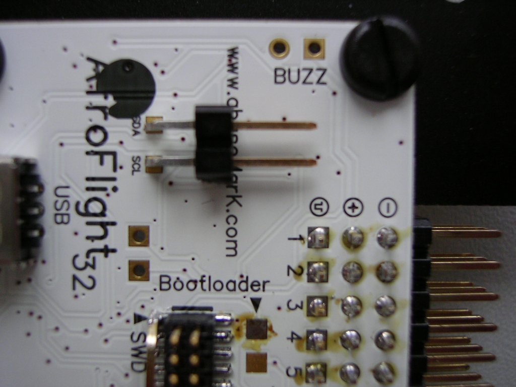 Nur lose aufgelegte 90° SMD Stiftleiste. Diese wird vor dem Löten mit Sekundenkleber fixiert. So gehen die Steckkräfte nicht (bzw. nicht nur) auf die SMD-Pads.